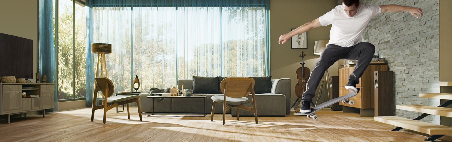Man on skateboard in living room with hardwood floor.
