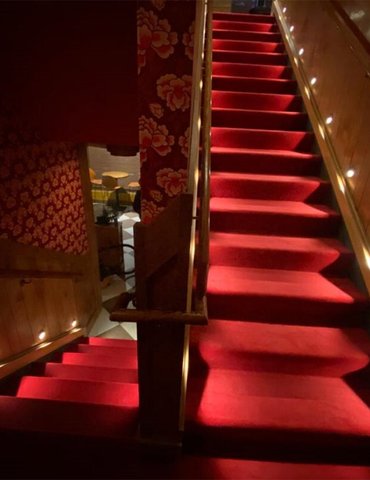 Beautiful red stair carpet installation for Blind Barber Bar by Philadelphia Flooring Solutions in Yorktown, PA